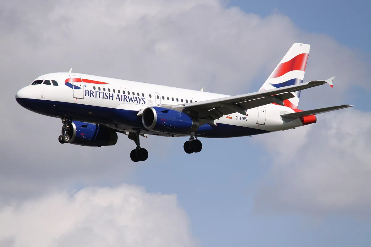 British Airways Airbus A319 G-EUPT on approach, its registration painted on the rear fuselage